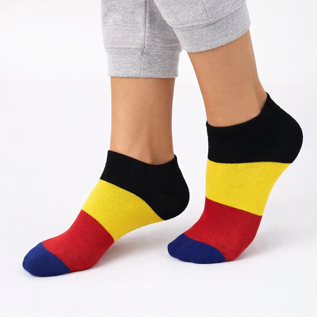 Colorful striped socks worn with gray pants on a white background