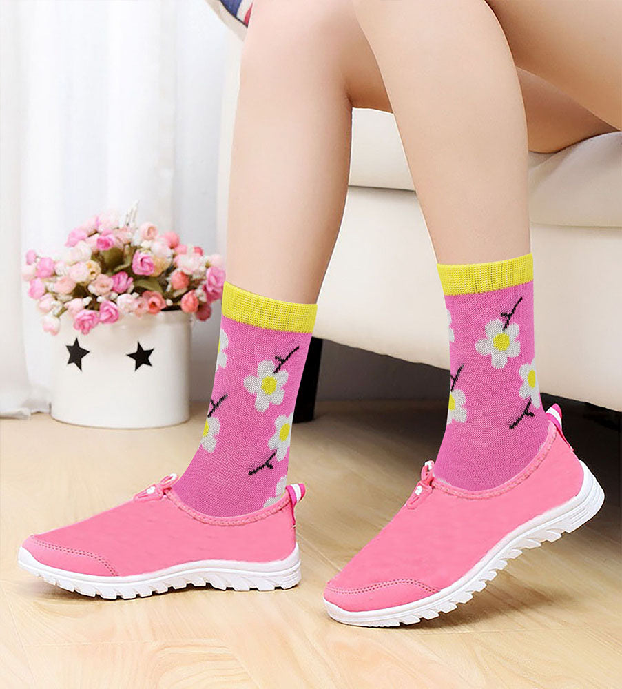 Girls wearing colorful novelty crew socks while playing at home